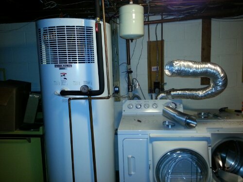 The grill on top of the water heater tank is where the air is drawn into the compressor. I've ducted out dryer so the air warm blows toward the water heater. That was a really bad idea because everything got very linty.