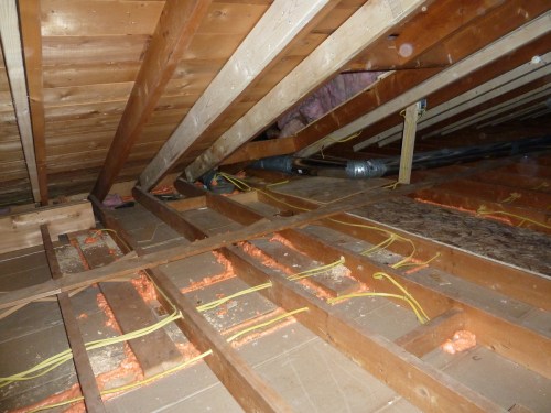 Making the inside of the house a different temperature from outdoors creates a pressure difference between inside and out.  The pressure causes air to move through holes and cracks of any size.  Even a hairline crack can leak all season long.  Uncontrolled leakage is the biggest cause of heat loss.  To save energy and keep the house comfortable, seal all holes and cracks, no matter how small.  Here one-part spray foam seals the crack between the ceiling drywall and the top plates of the partition walls.