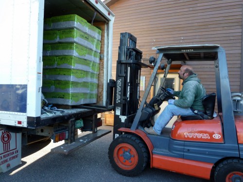 I estimated the materials for the job by figuring the surface area of the ceiling, mulitplying by the thickness I wanted, adding in the amount for the garage wall, and looking up the coverage for the product we ordered.  It turned out to be a lot more insulation than I expected.  We filled the truck once, and had to go back to Nik's shop in the middle of the day and load up the remaining bails.