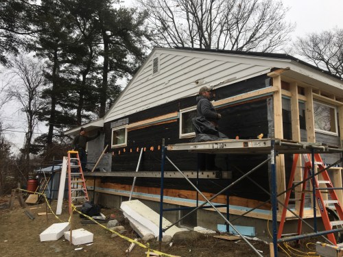 After the siding is removed ledgers are mounted to wall with 1.5